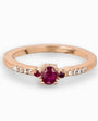Anillo en oro rosa con rubí central y diamantes laterales.