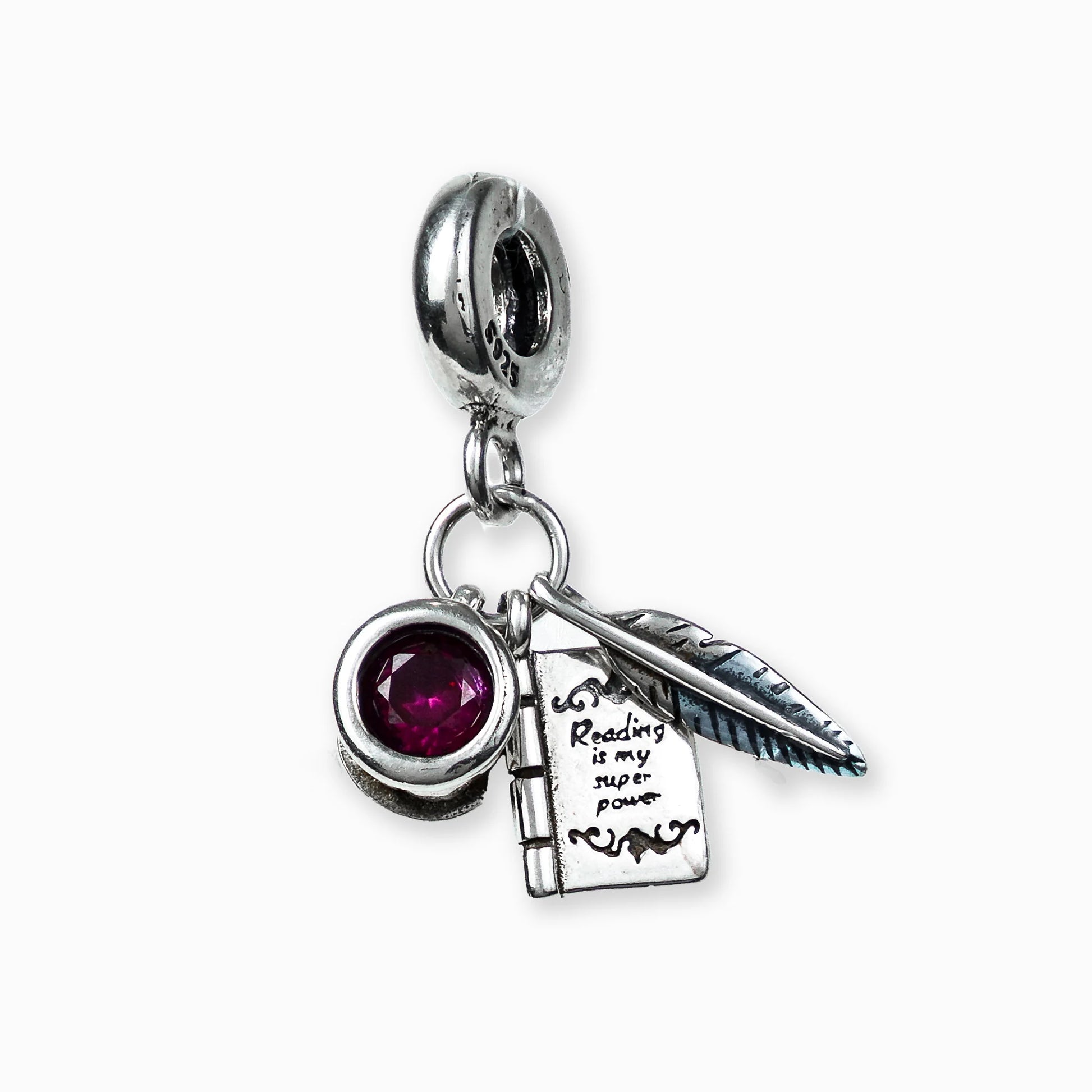 Dije con temática de escritor y circon rojo en plata ley 925.
