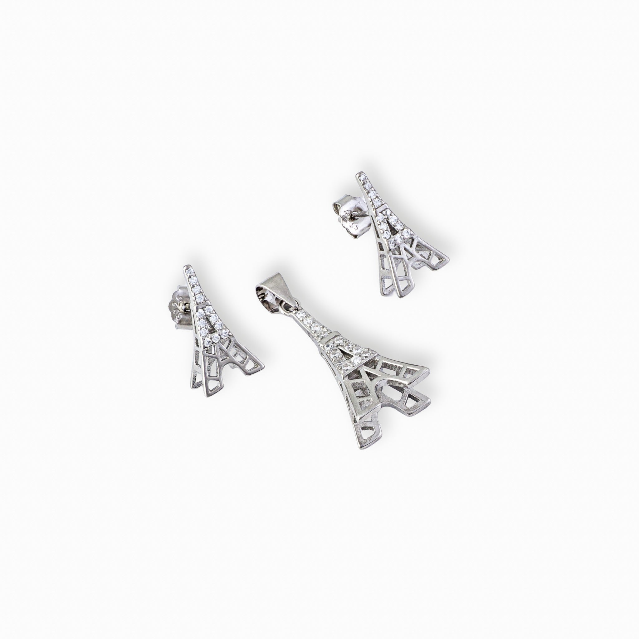 Juego de joyería en plata ley 925 con baño de rodio con diseño de la Torre Eiffel, incluye aretes de topo y dije sobre fondo blanco.
