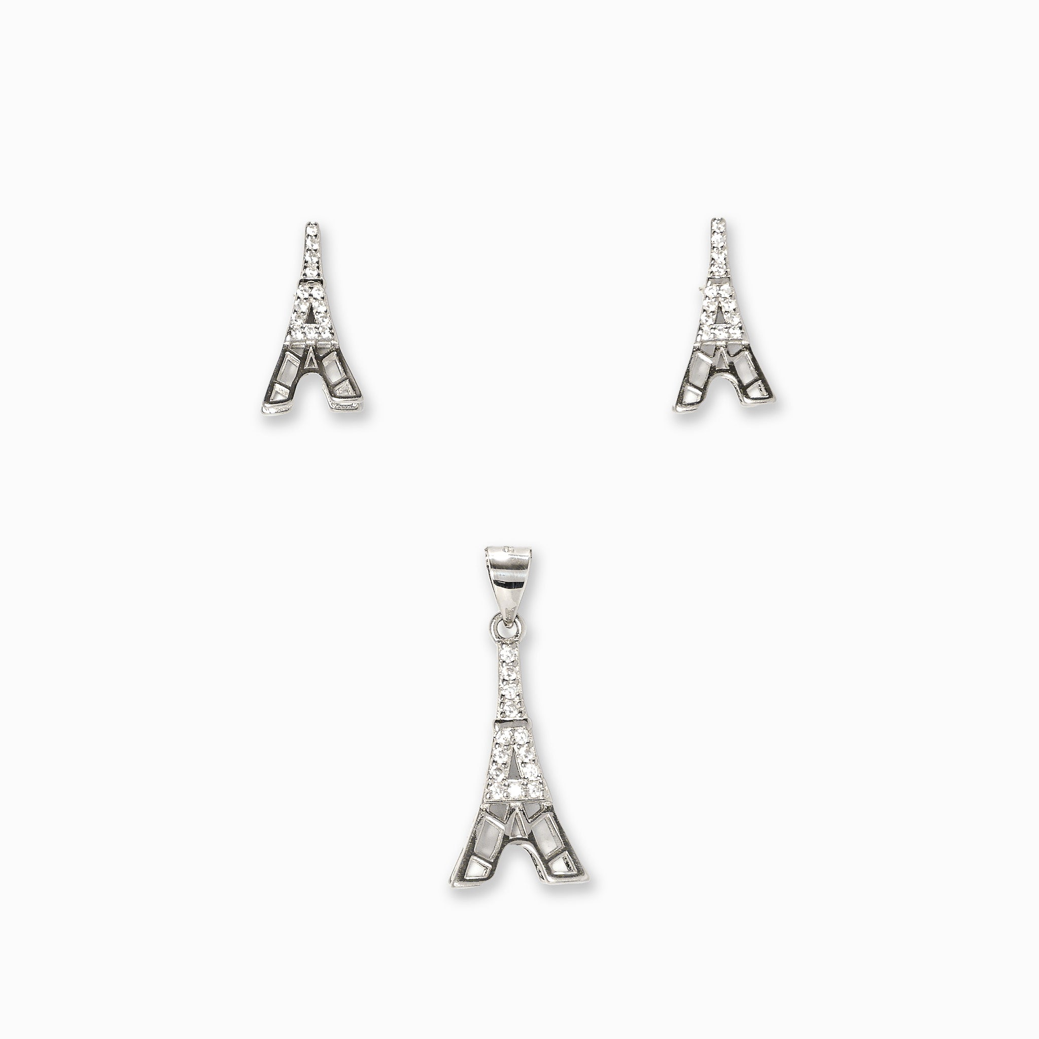 Juego de joyería en plata ley 925 con baño de rodio con diseño de la Torre Eiffel, incluye aretes de topo y dije sobre fondo blanco.
