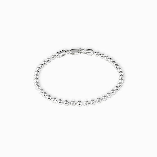 Pulsera de balines esféricos y lisos de 3 mm de diámetro elaborada en plata ley 925 de 19 cm de largo sobre fondo blanco.
