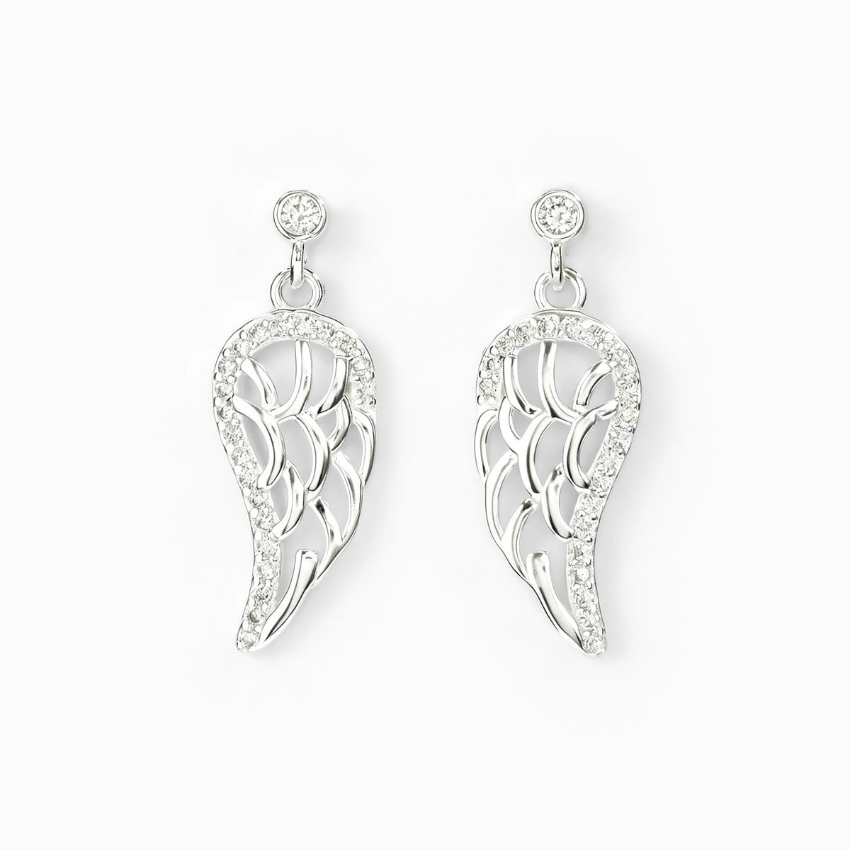 Juego de aretes colgantes y dije en forma de ala celestial calada en plata ley 925 con circones.