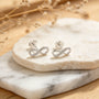 Topos con diseño de símbolo infinito de 12x4 mm en plata ley 925 y circones blancos