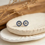 Topos de ojo turco en plata ley 925 de 7 mm con circones azules y blancos.