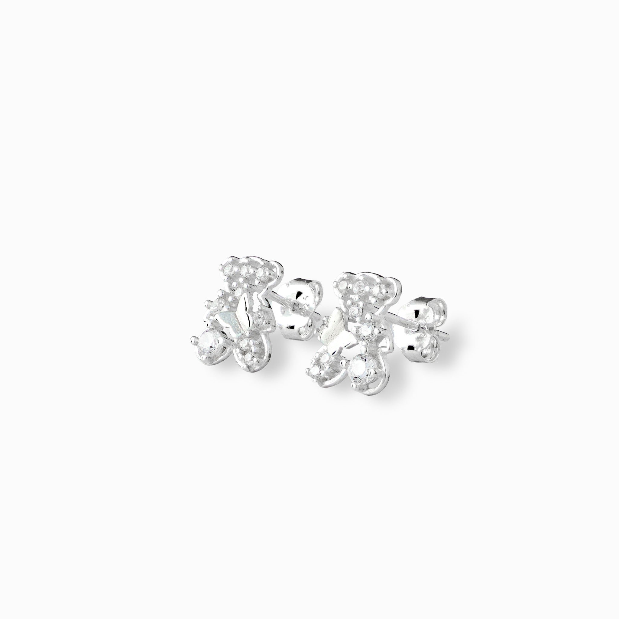 Par de aretes tipo topo con forma de osito y circón transparente central elaborados en plata ley 925 de 10 mm de alto sobre fondo blanco.
